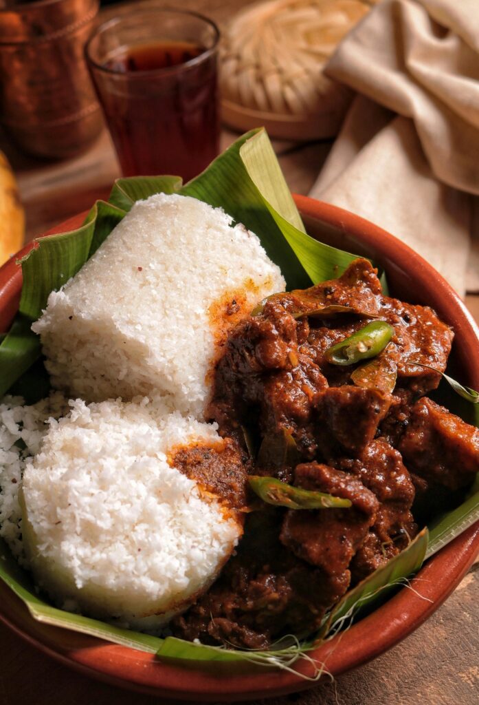 Puttu And Beef Curry Served On a Banana Leaf