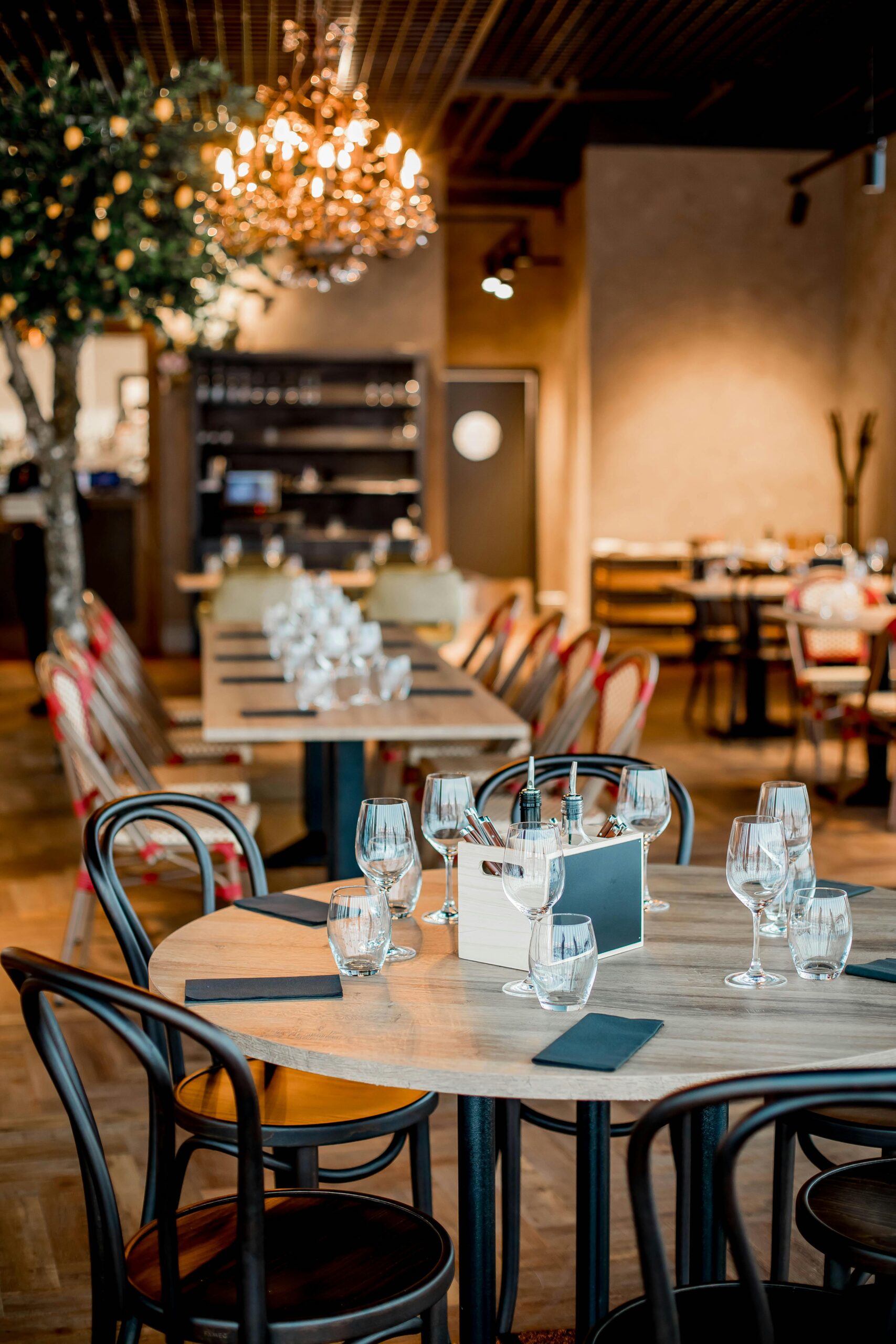 Elegant restaurant interior with neatly arranged tables and warm lighting, creating a cozy dining atmosphere.