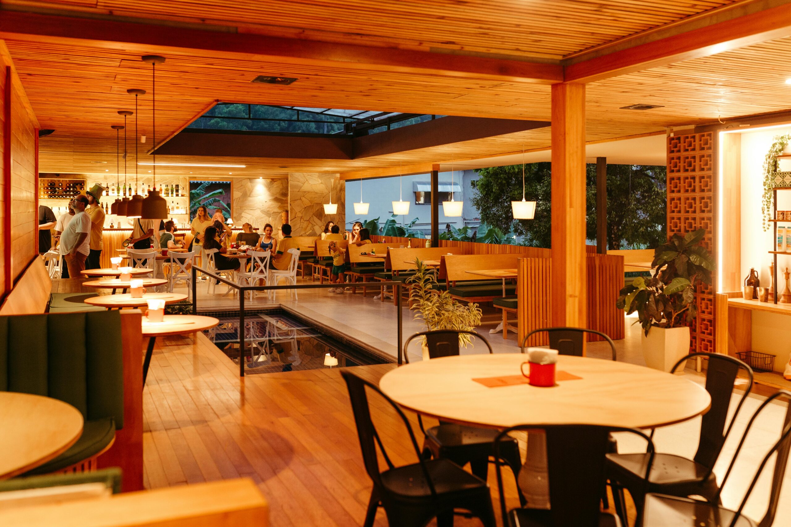 Warm and inviting restaurant interior with wooden decor and ambient lighting.