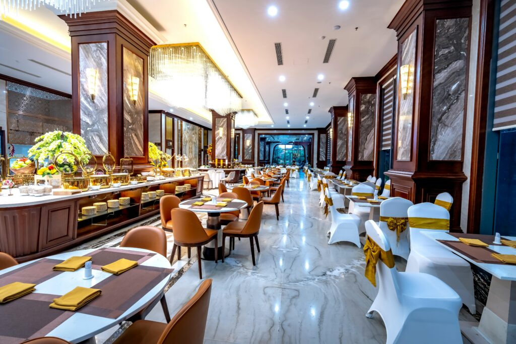 Elegant hotel dining room with luxurious decor and seating arrangement.